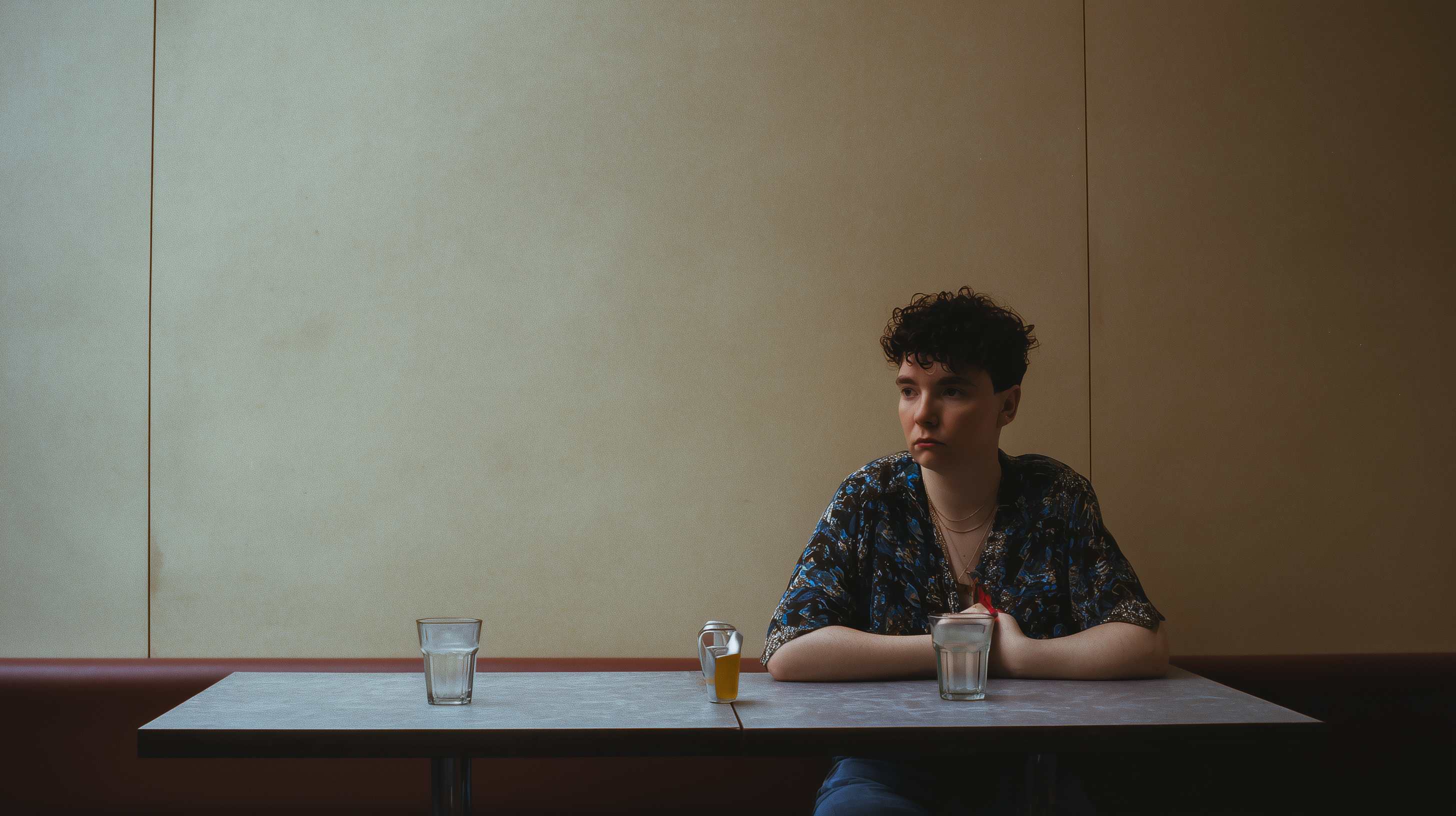 Person sitting alone at a cafe table